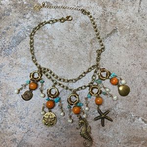 Gold Nautical Necklace with orange and turquoise accents.